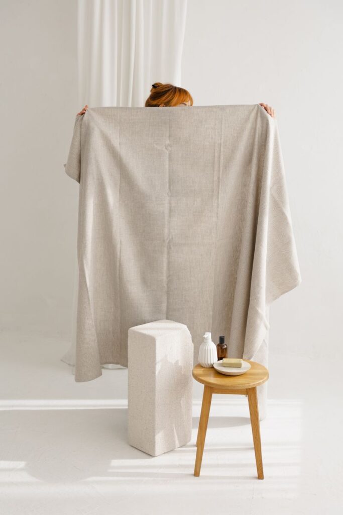 White natural linen waffle towel styled for beach, holiday, or travel use